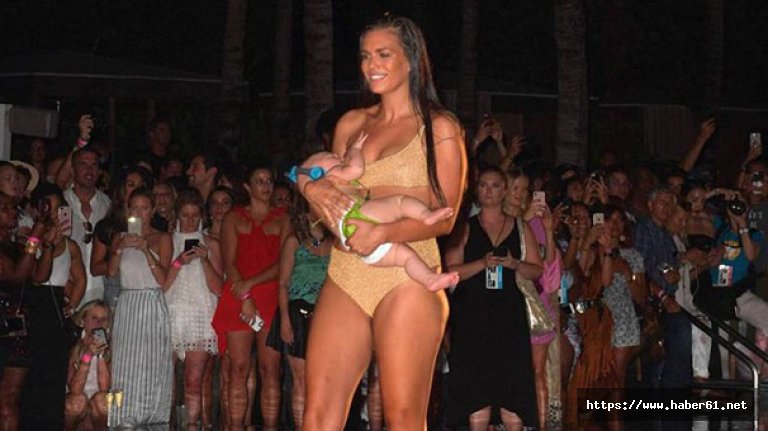 Beş aylık kızını emzirerek podyumda yürüdü!