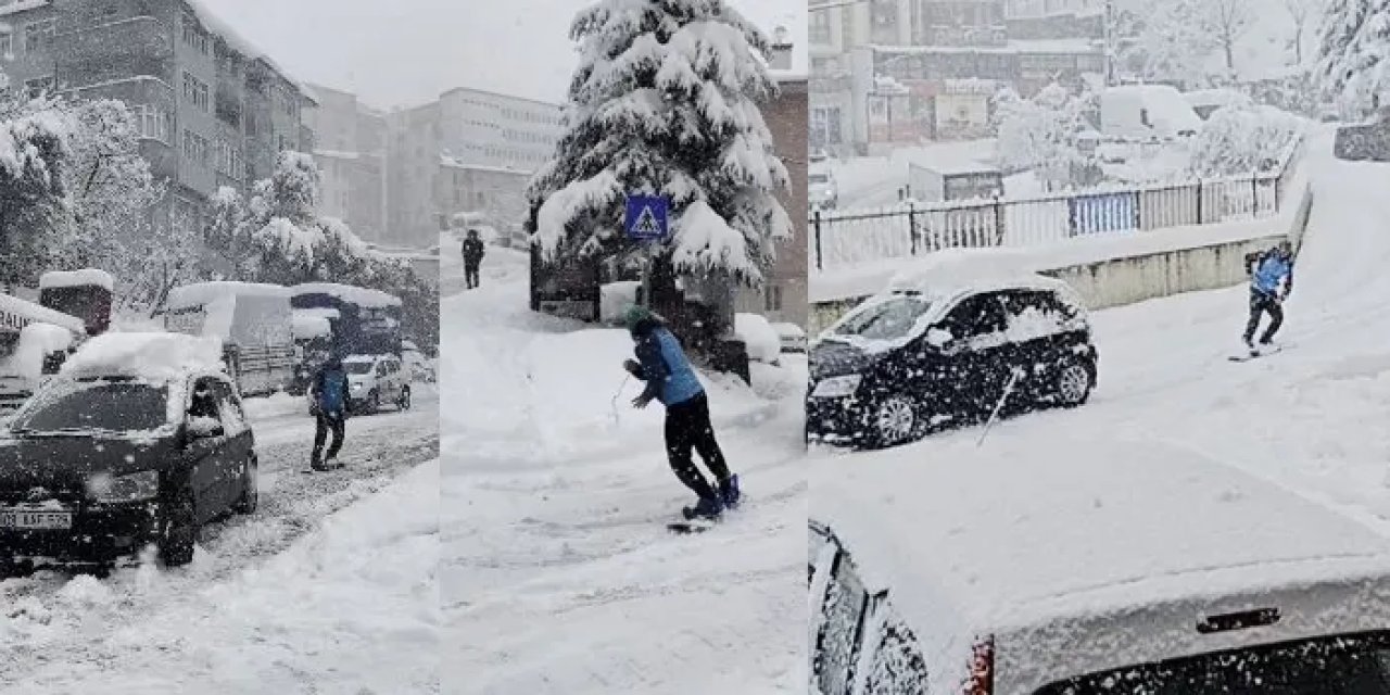 Artvin’de karlı kaplı yolda işe snowbordla gitti